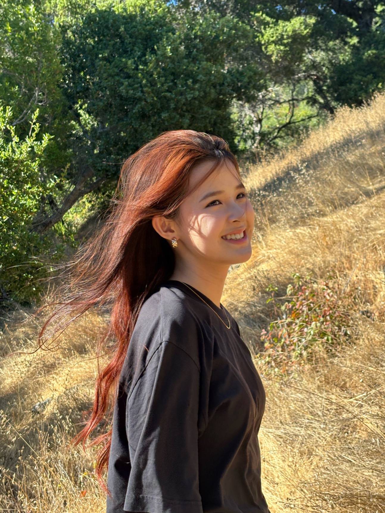 May smiling on a sunlit trail