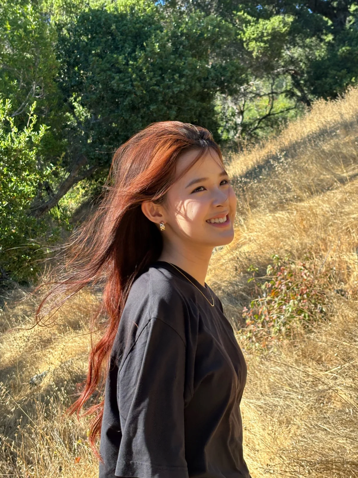 May smiling on a sunlit trail