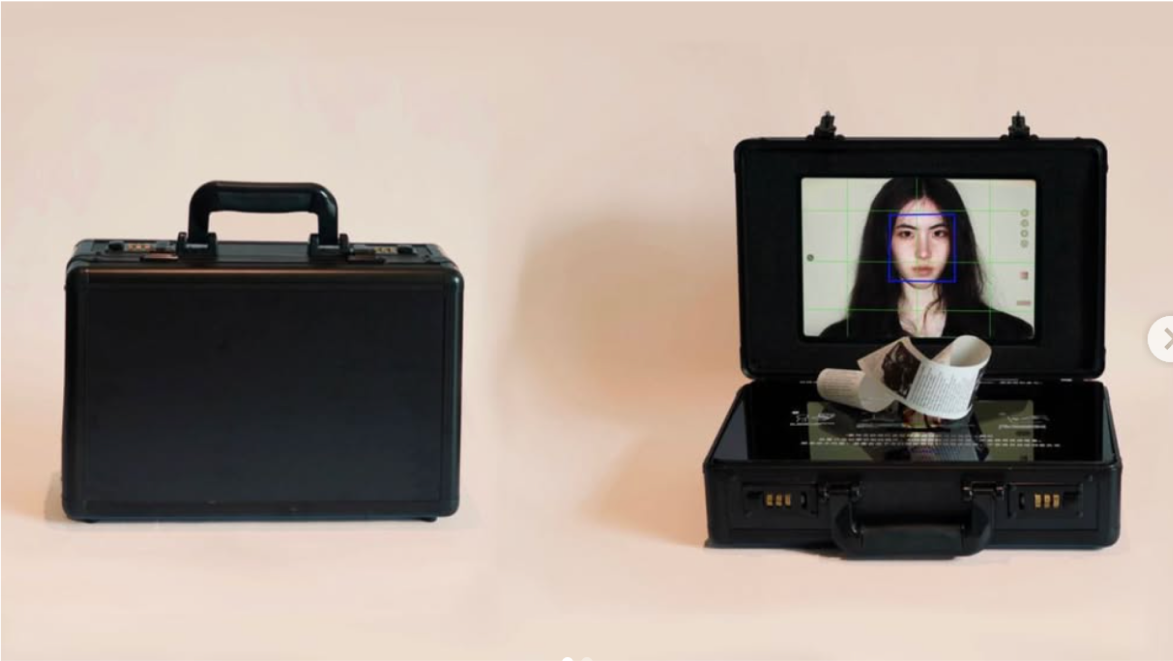 Two black cases, one opened to reveal a portrait-scanning screen and printed output