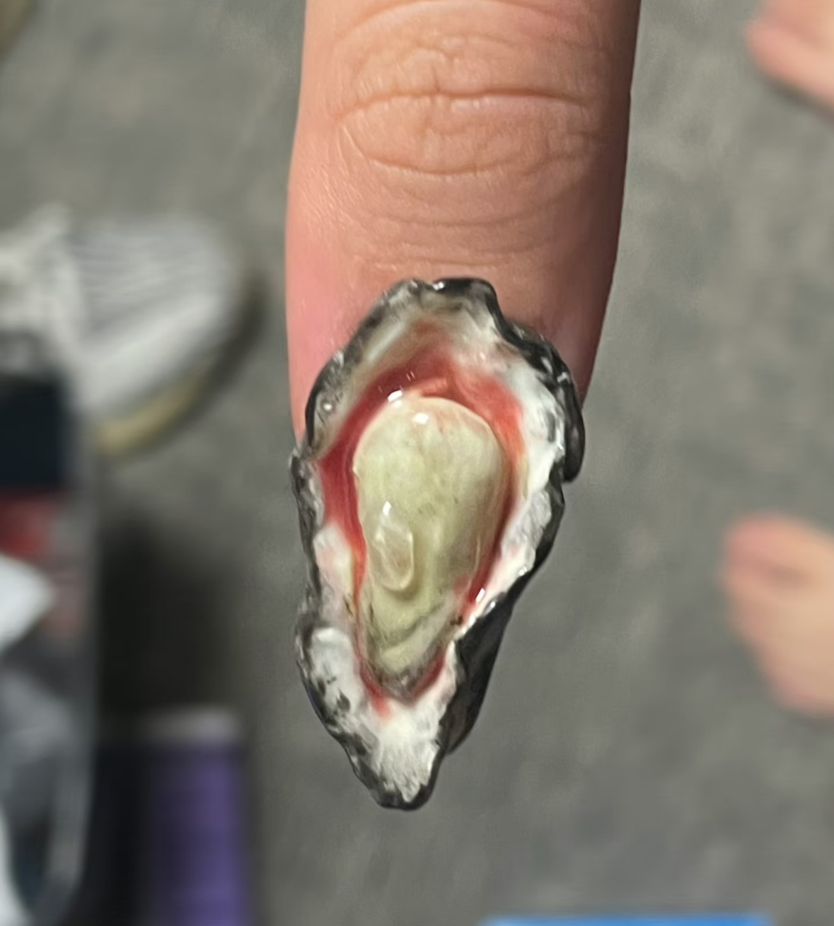 A sculptural oyster-shell nail design being worn outdoors